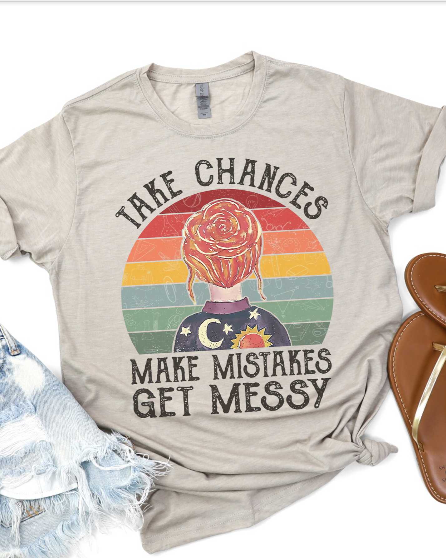 Beige retro rainbow tee with “Take Chances Make Mistakes Get Messy” quote and graphic.
