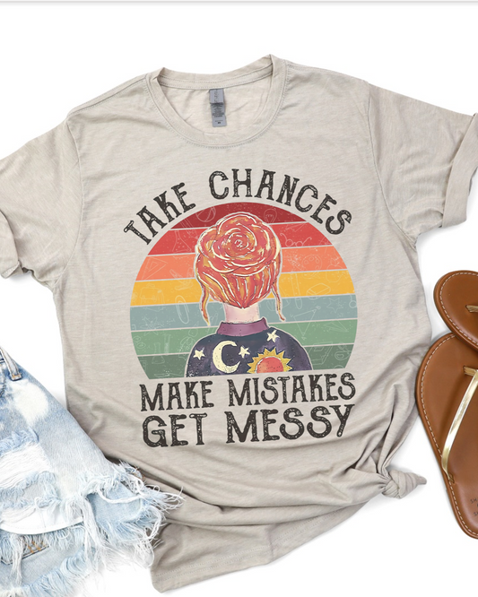 Beige retro rainbow tee with “Take Chances Make Mistakes Get Messy” quote and graphic.