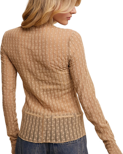 Woman wearing a tan semi-sheer top on a white background.