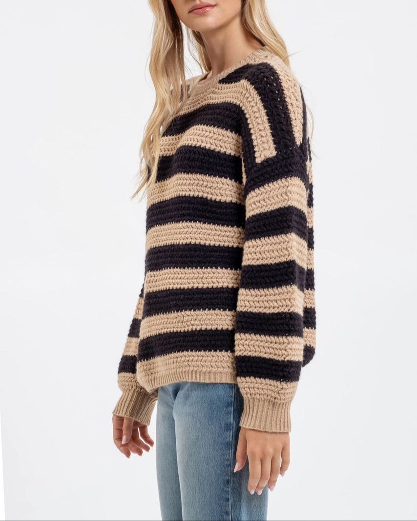 Woman wearing a striped sweater on a white background