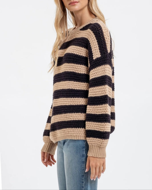 Woman wearing a striped sweater on a white background