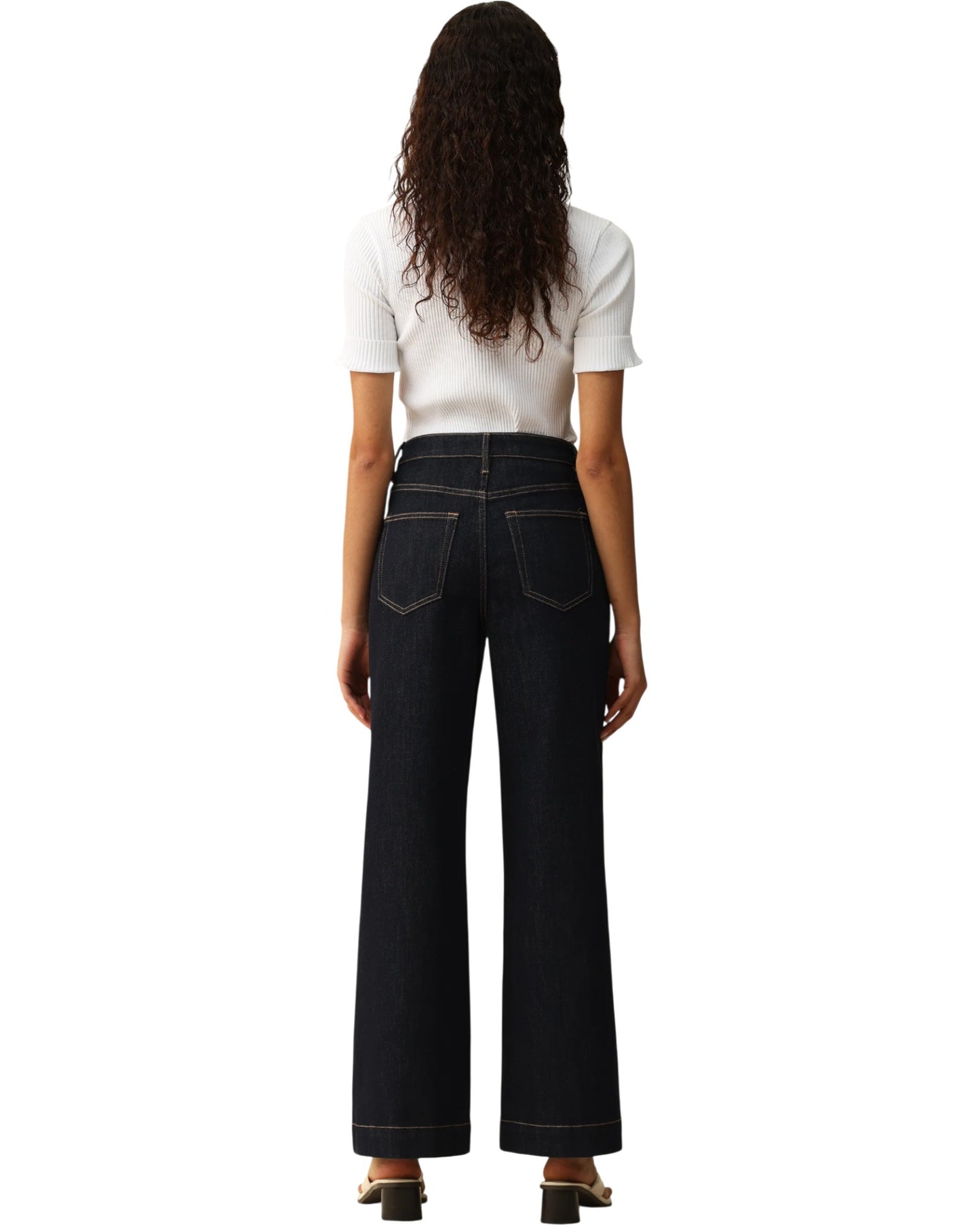 Person wearing dark blue wide-leg trouser-style jeans on a white background.