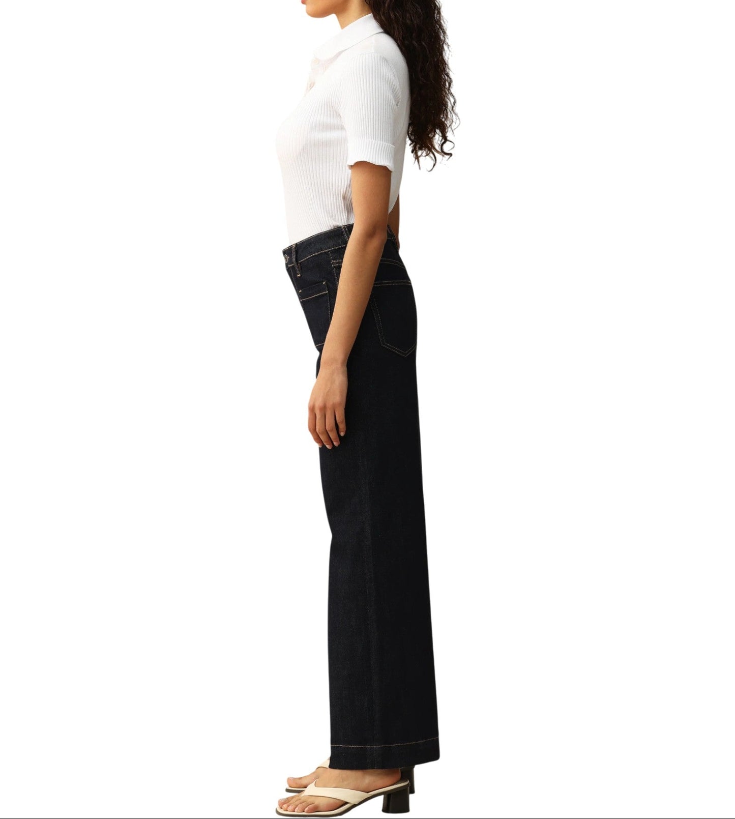 Person wearing dark blue wide-leg trouser-style jeans on a white background.