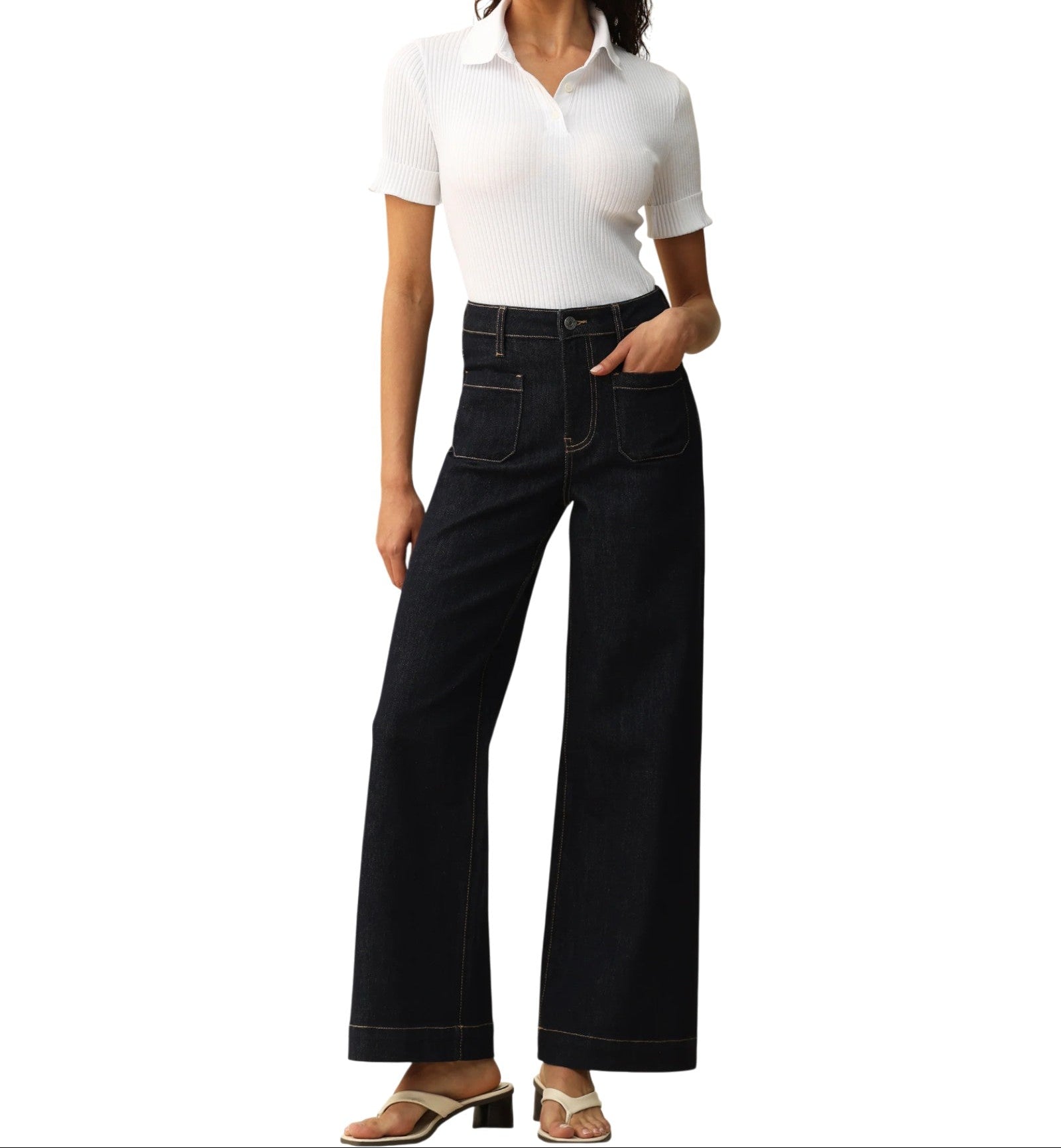 Person wearing dark blue wide-leg trouser-style jeans on a white background.