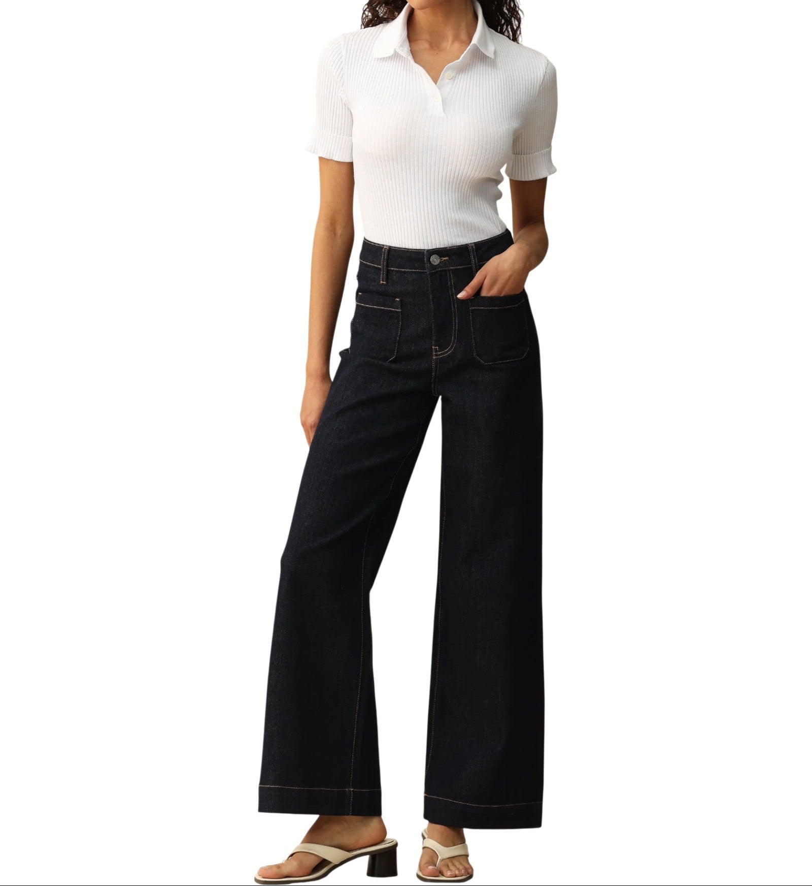 Person wearing dark blue wide-leg trouser-style jeans on a white background.