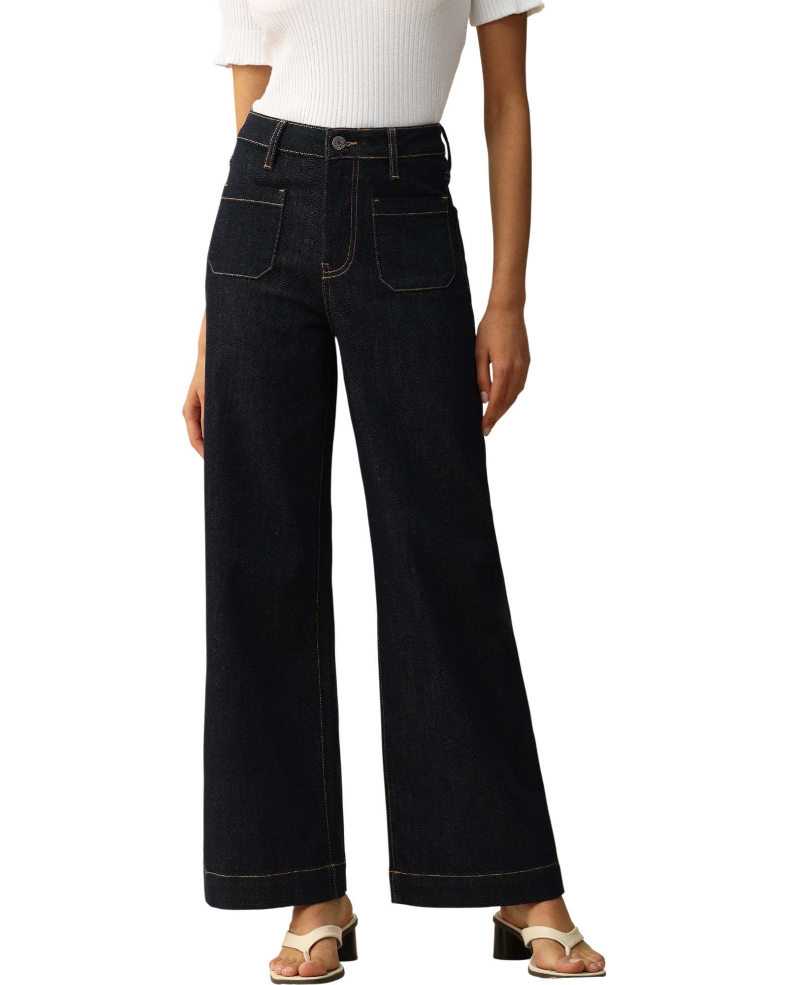 Person wearing dark blue wide-leg trouser-style jeans on a white background.