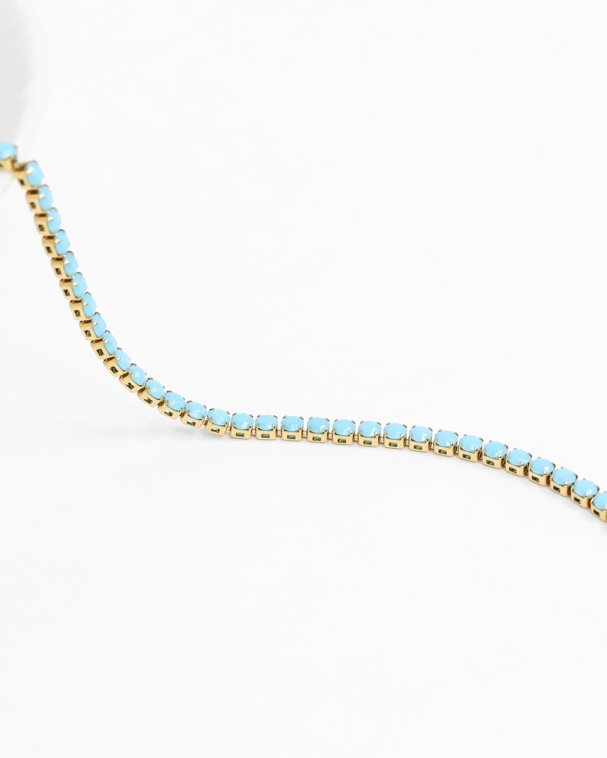 Turquoise rhinestone tennis chain necklace with gold finish and extender clasp.