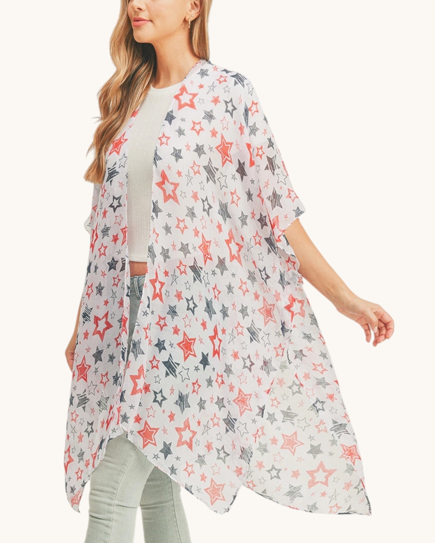 Woman wearing a star-patterned kimono-style garment on a white background. 