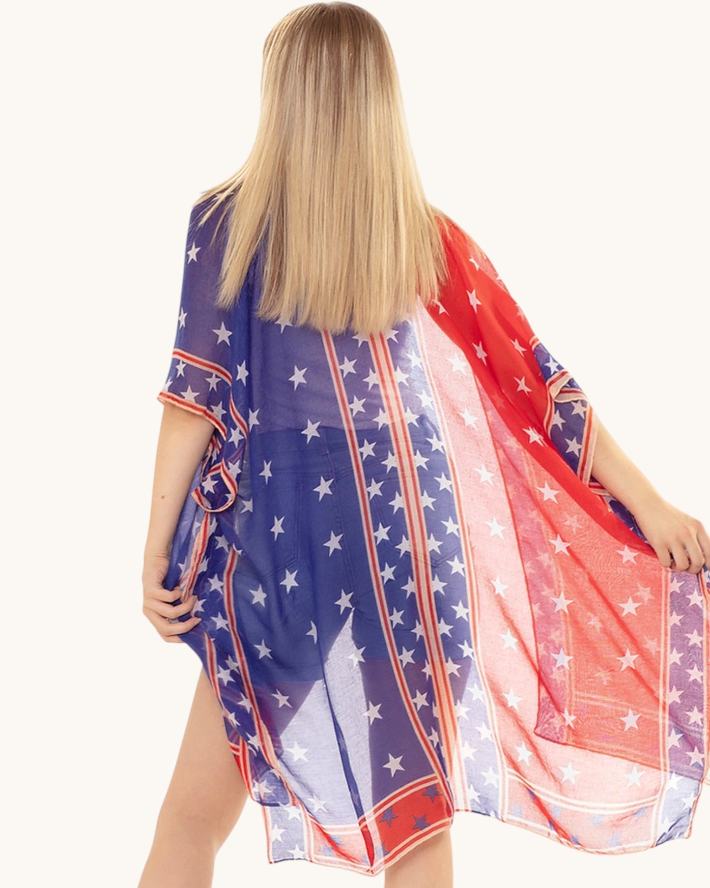 Woman wearing a colorful American flag patterned wrap on a white background.