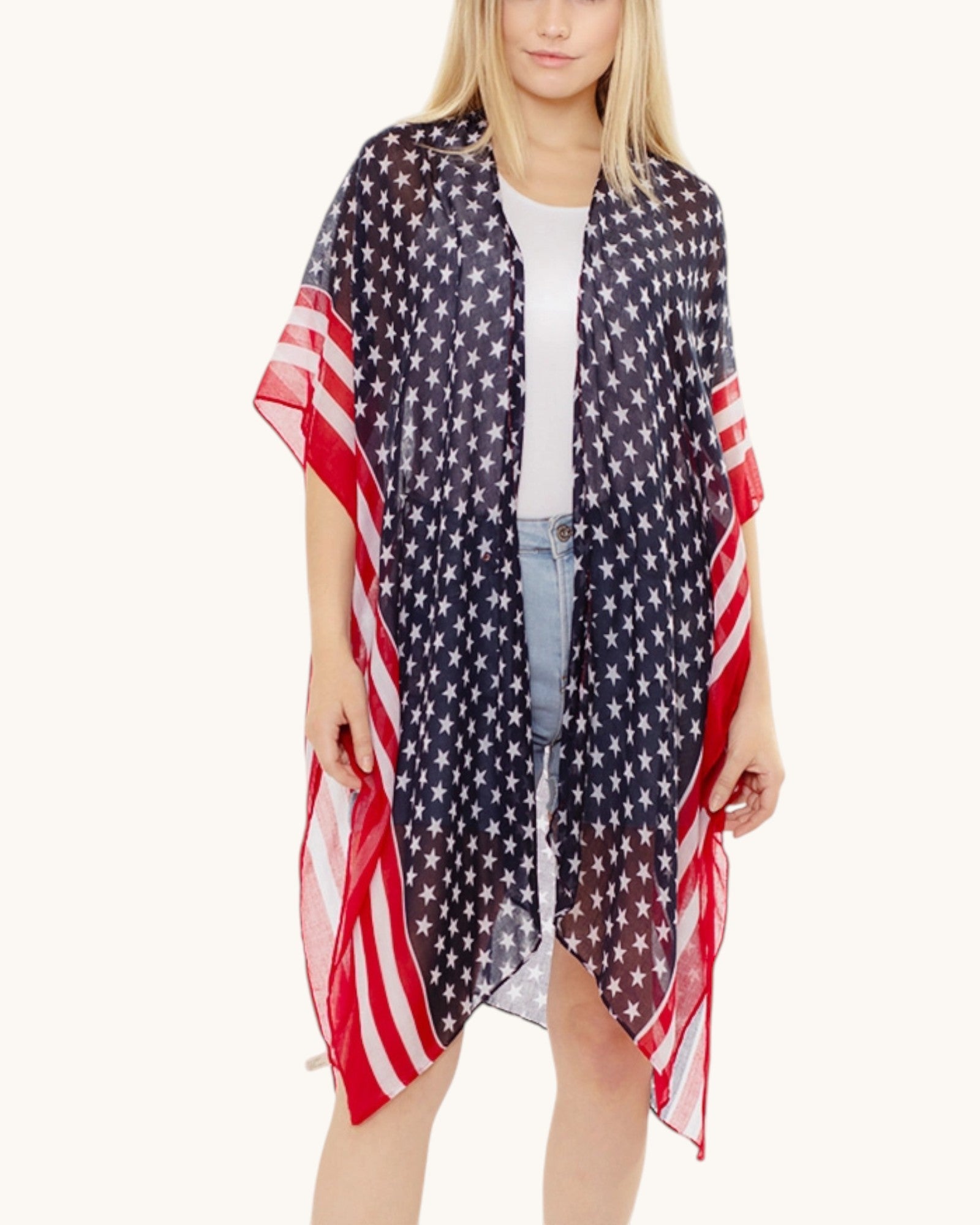 Woman wearing a American flag patterned kimono / cover up on a white background.