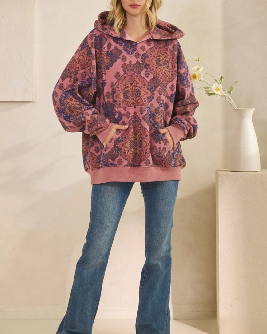 Woman wearing a Mauve Medallion patterned hoodie against a plain background.