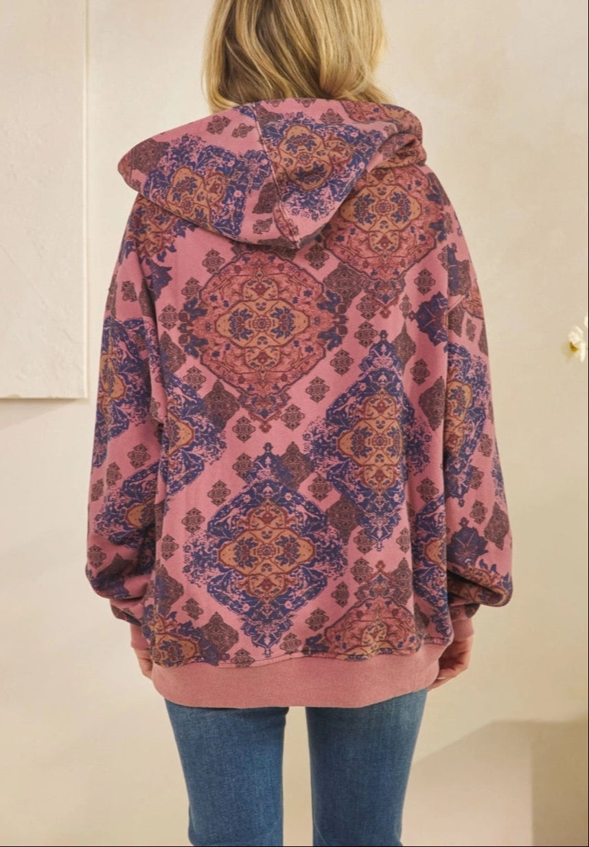 Woman wearing a Mauve Medallion patterned hoodie against a plain background.