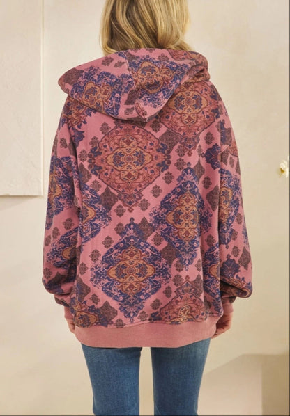 Woman wearing a Mauve Medallion patterned hoodie against a plain background.