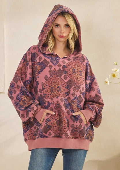 Woman wearing a Mauve Medallion patterned hoodie against a plain background.