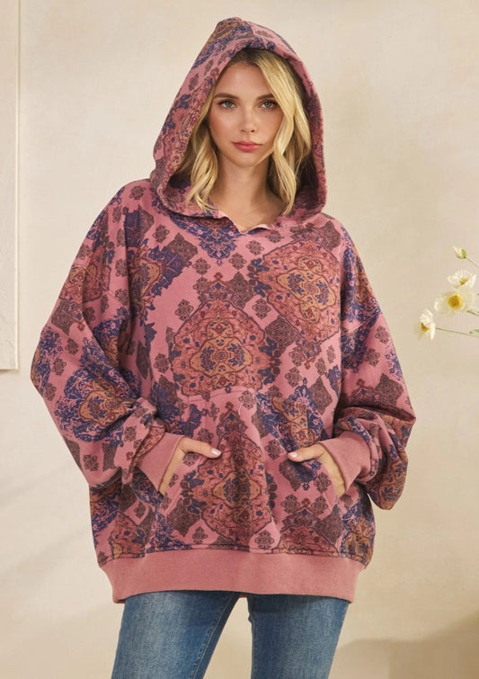 Woman wearing a Mauve Medallion patterned hoodie against a plain background.