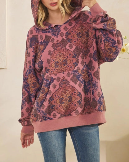 Woman wearing a Mauve Medallion patterned hoodie against a plain background.
