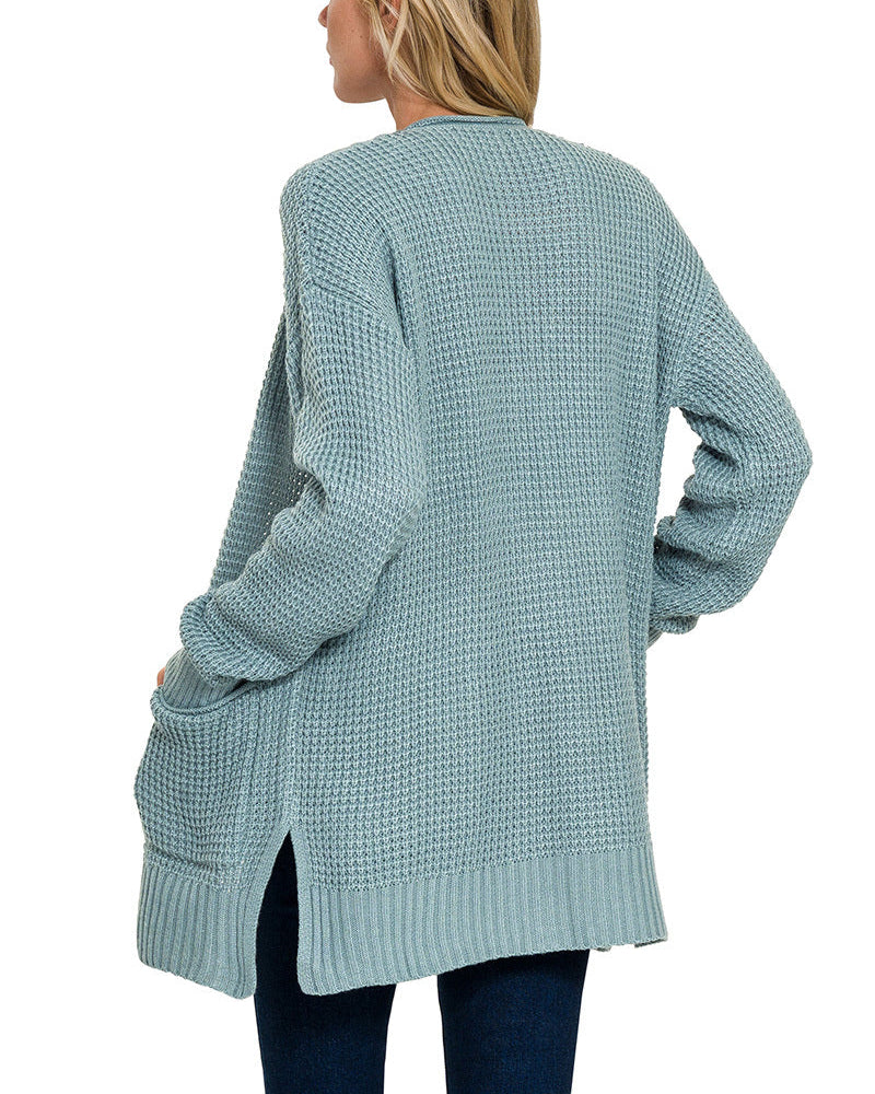 Light blue waffle knit cardigan worn by a person on a white background.