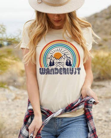Vanilla tee with retro rainbow and mountain scene above “Wanderlust” text.