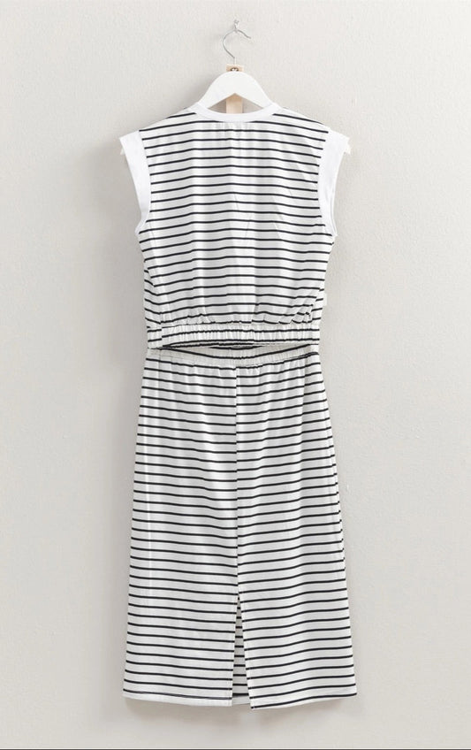Striped black and white skirt and top set on a hanger against a white background.