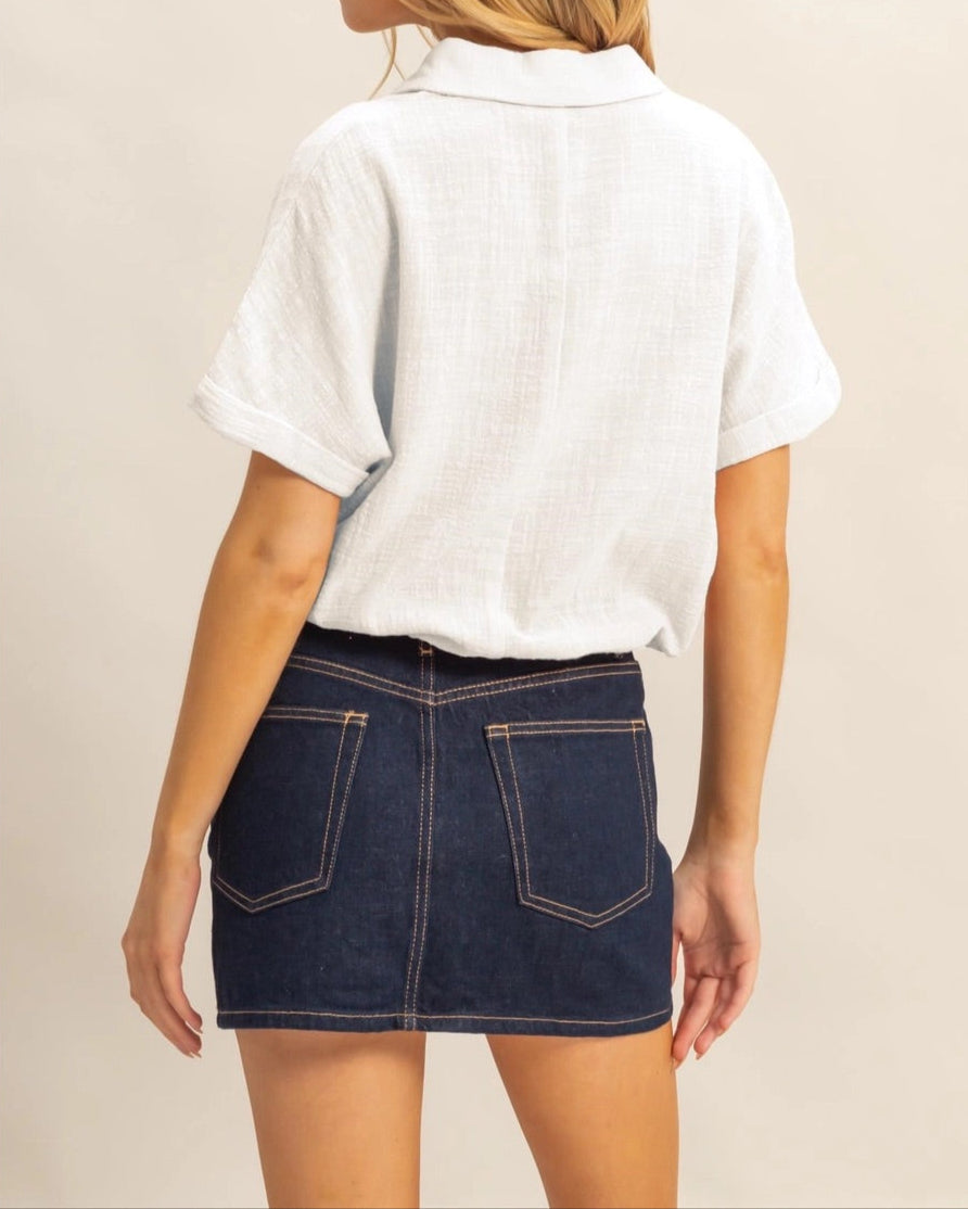 White short sleeve cotton button-up shirt with drawstring hem.