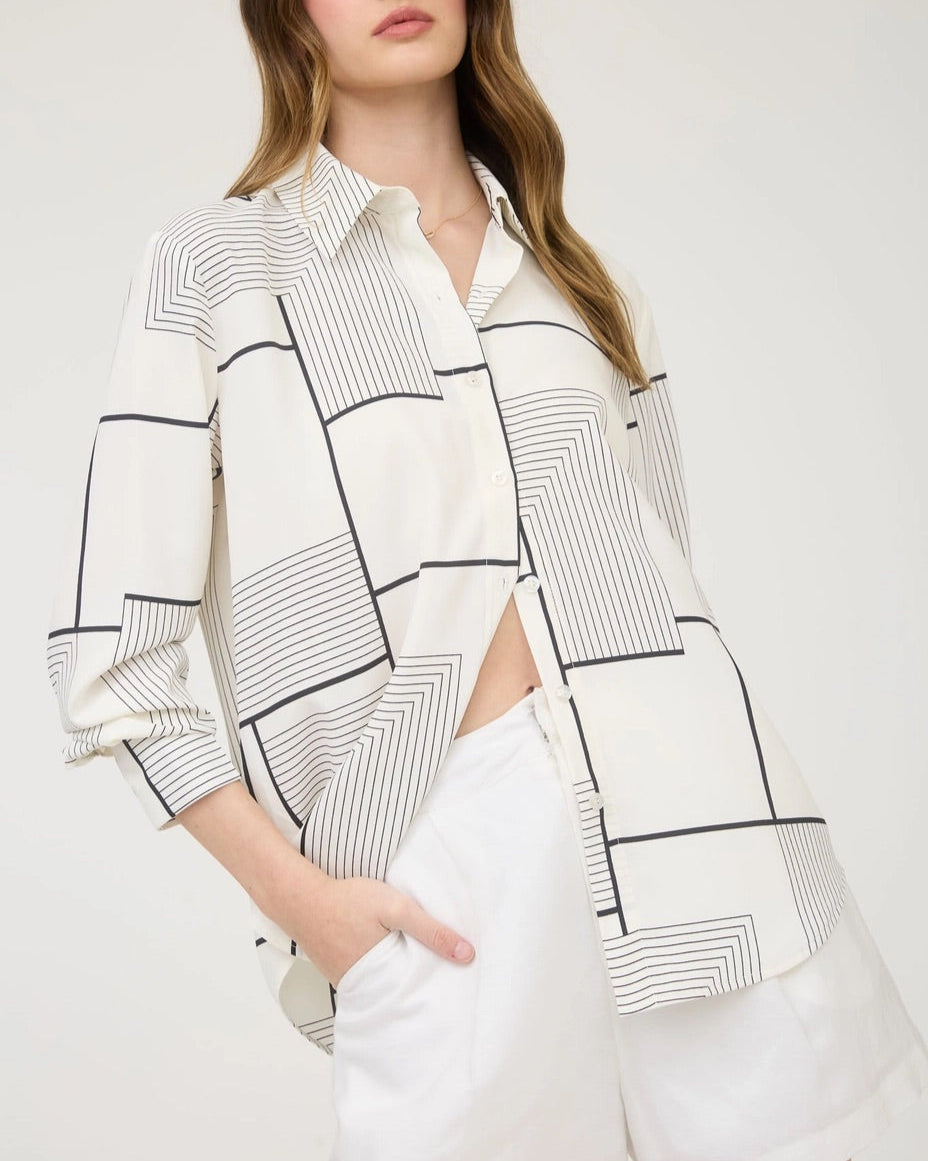 Black and white geometric print button down shirt with collared neckline. 