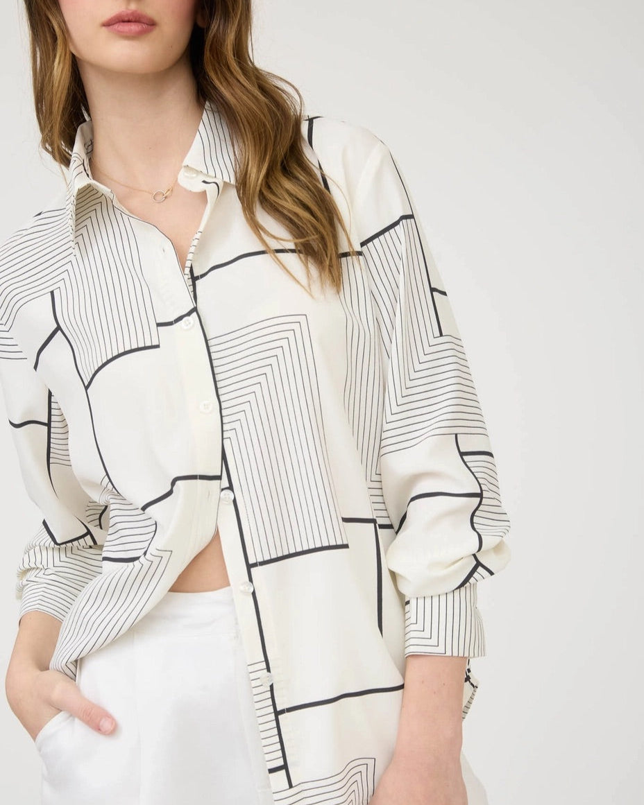 Black and white geometric print button down shirt with collared neckline.