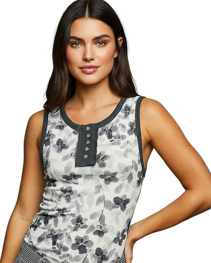 Woman wearing a white and charcoal floral boho-style tank top. 