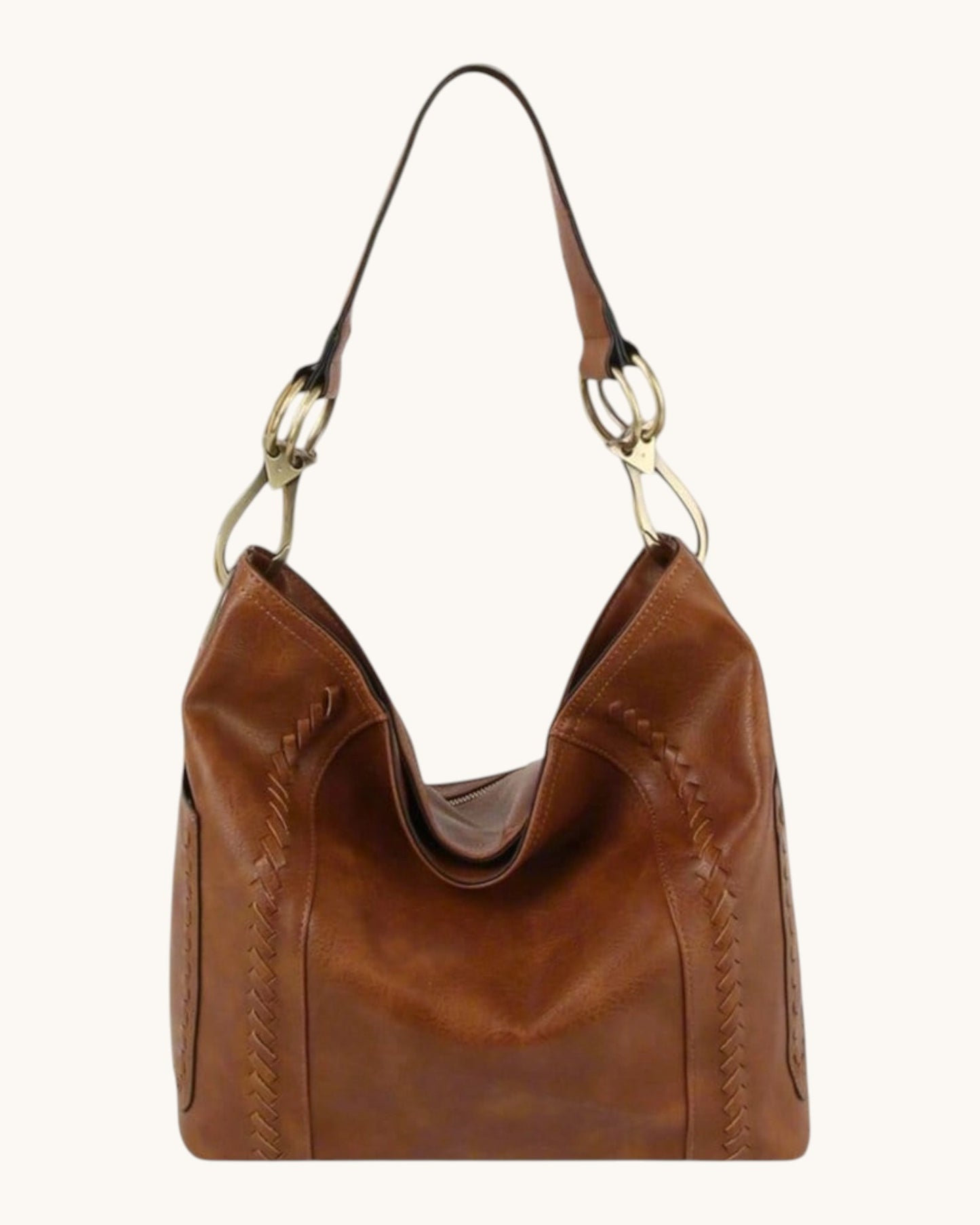 Brown leather hobo handbag with bronze hardware on a white background.