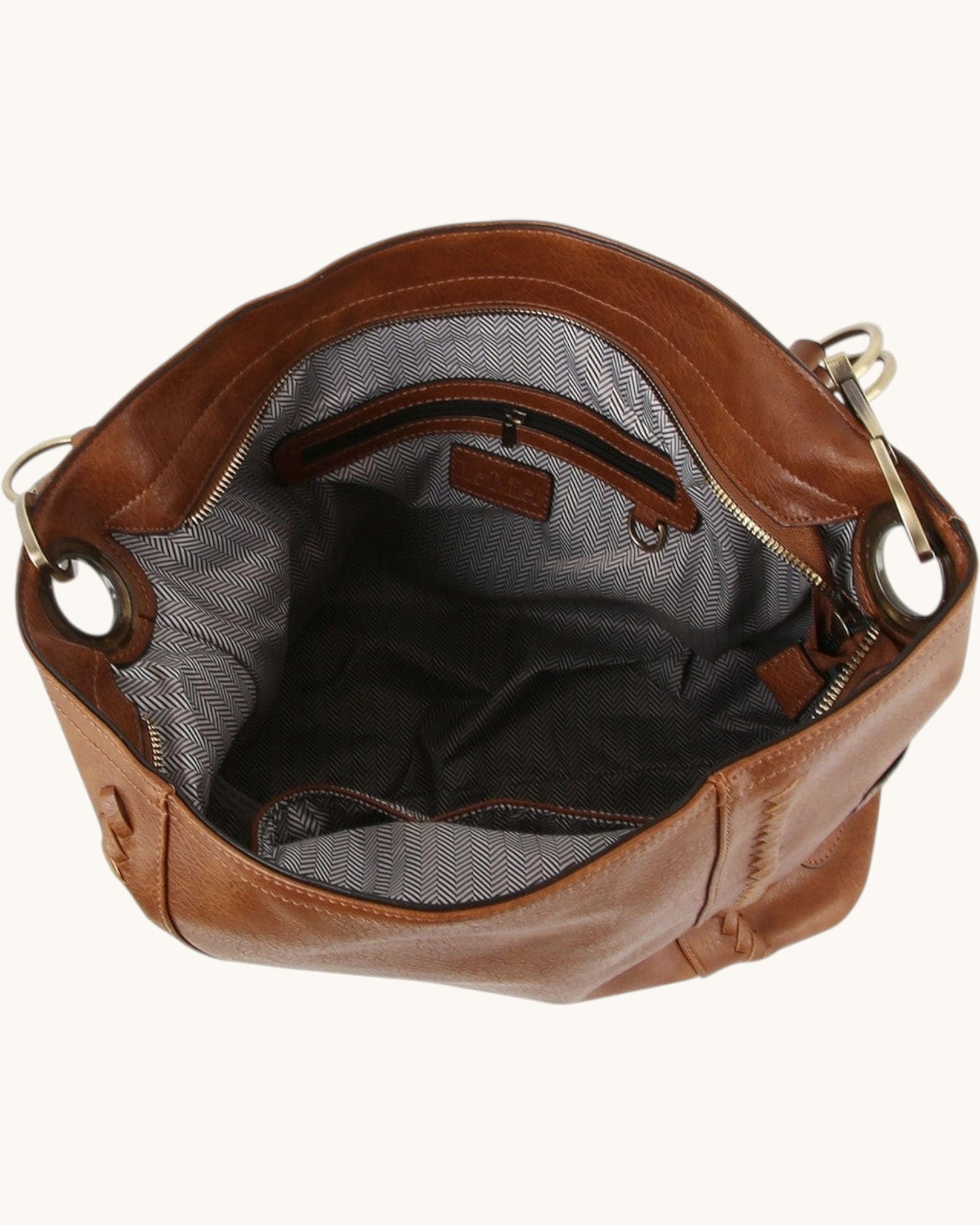 Brown leather hobo handbag with bronze hardware on a white background.