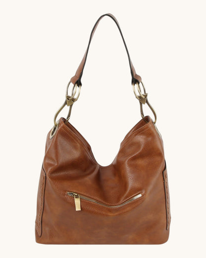 Brown leather hobo handbag with bronze hardware on a white background.