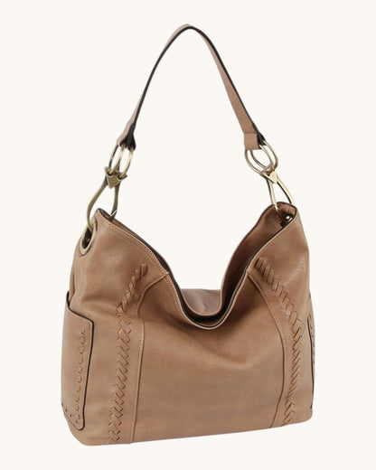 Brown leather hobo handbag with bronze hardware on a white background.