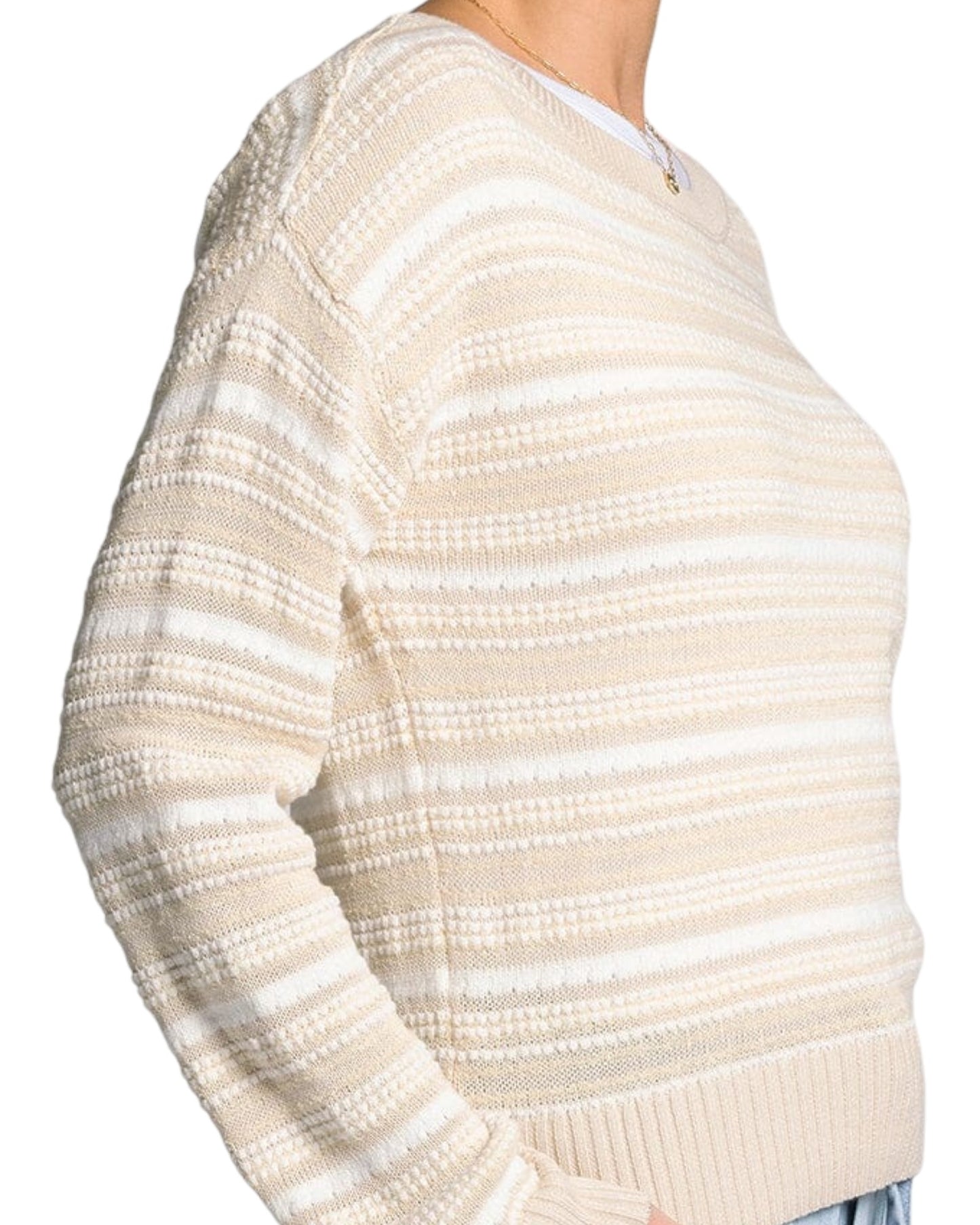 White and light beige textured knit sweater with boat neckline and relaxed fit.