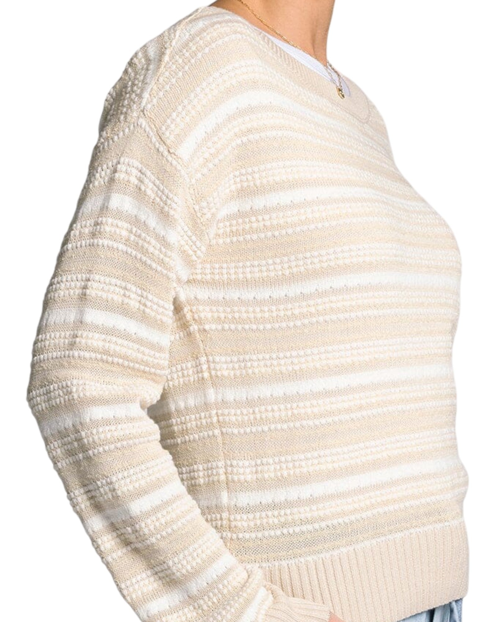 White and light beige textured knit sweater with boat neckline and relaxed fit.