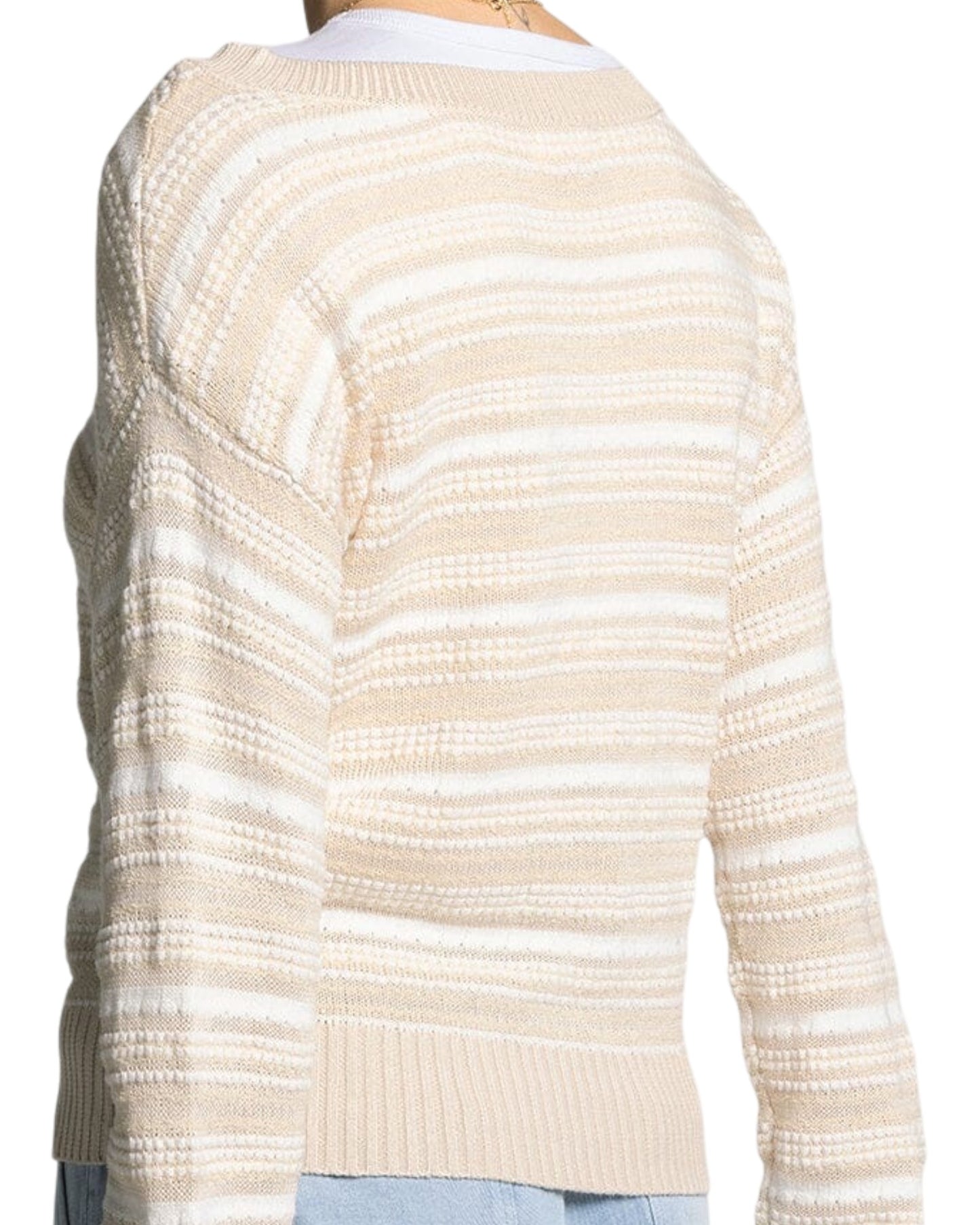White and light beige textured knit sweater with boat neckline and relaxed fit.
