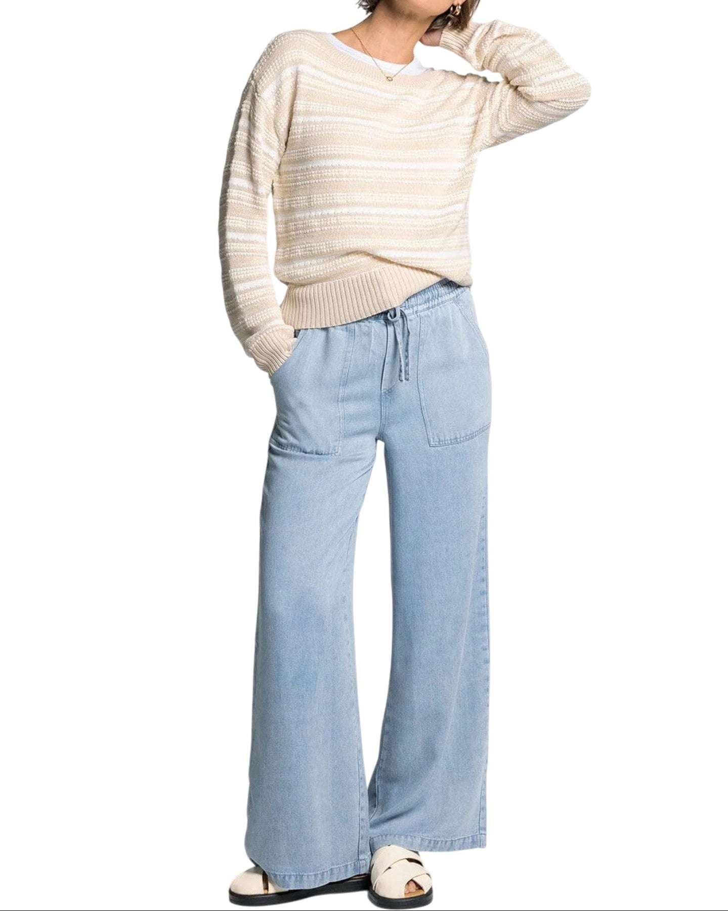 White and light beige textured knit sweater with boat neckline and relaxed fit.