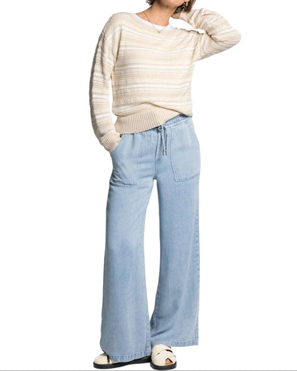 White and light beige textured knit sweater with boat neckline and relaxed fit.