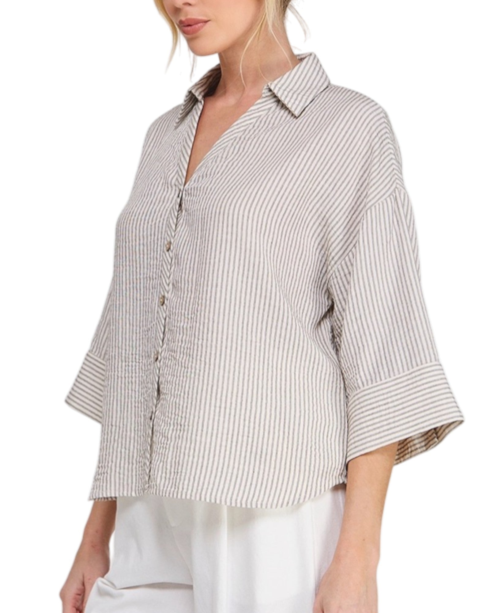 Woman wearing a striped shirt with 3/4 sleeves on a white background.