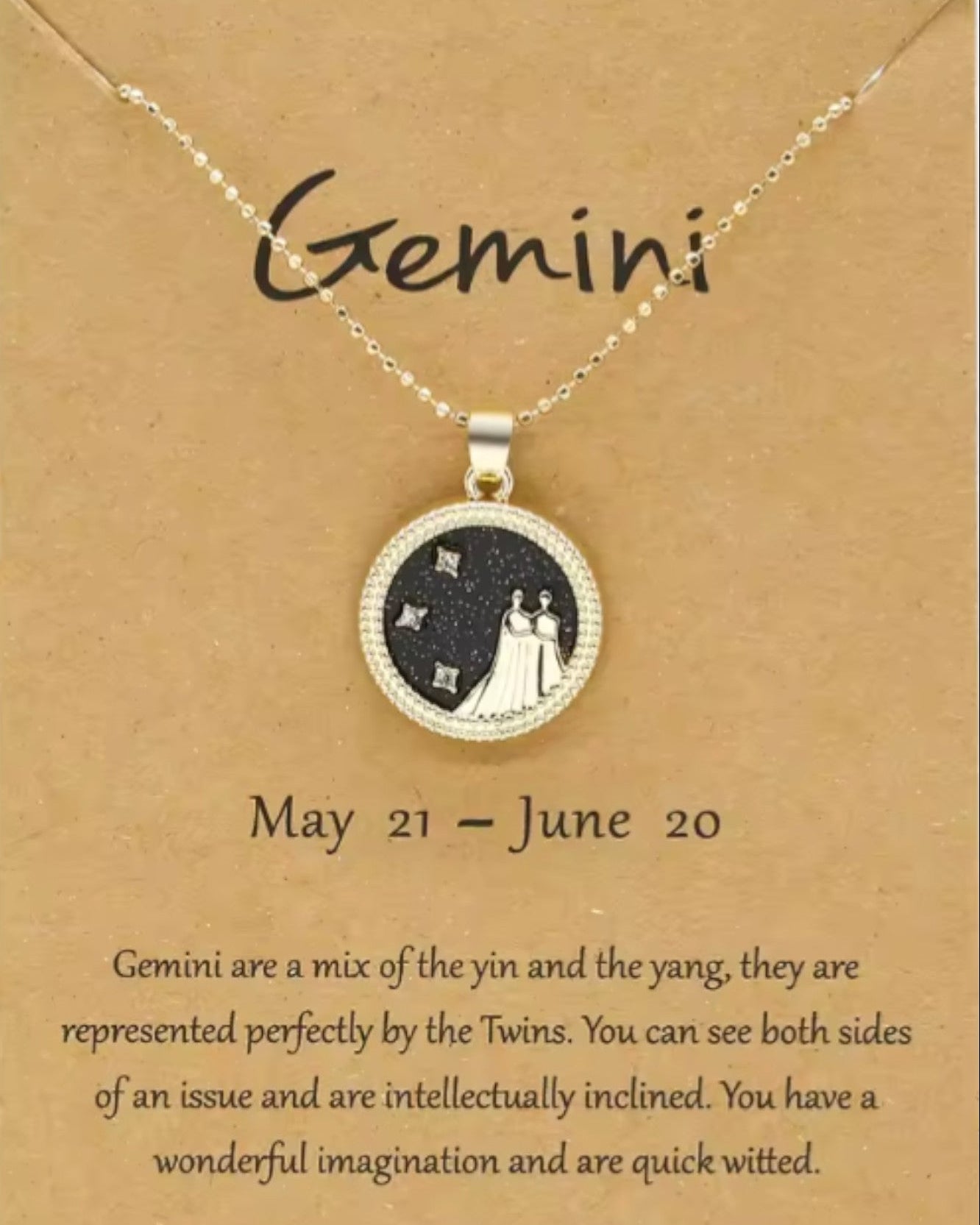 Necklace with Gemini zodiac sign pendant on a brown card.
