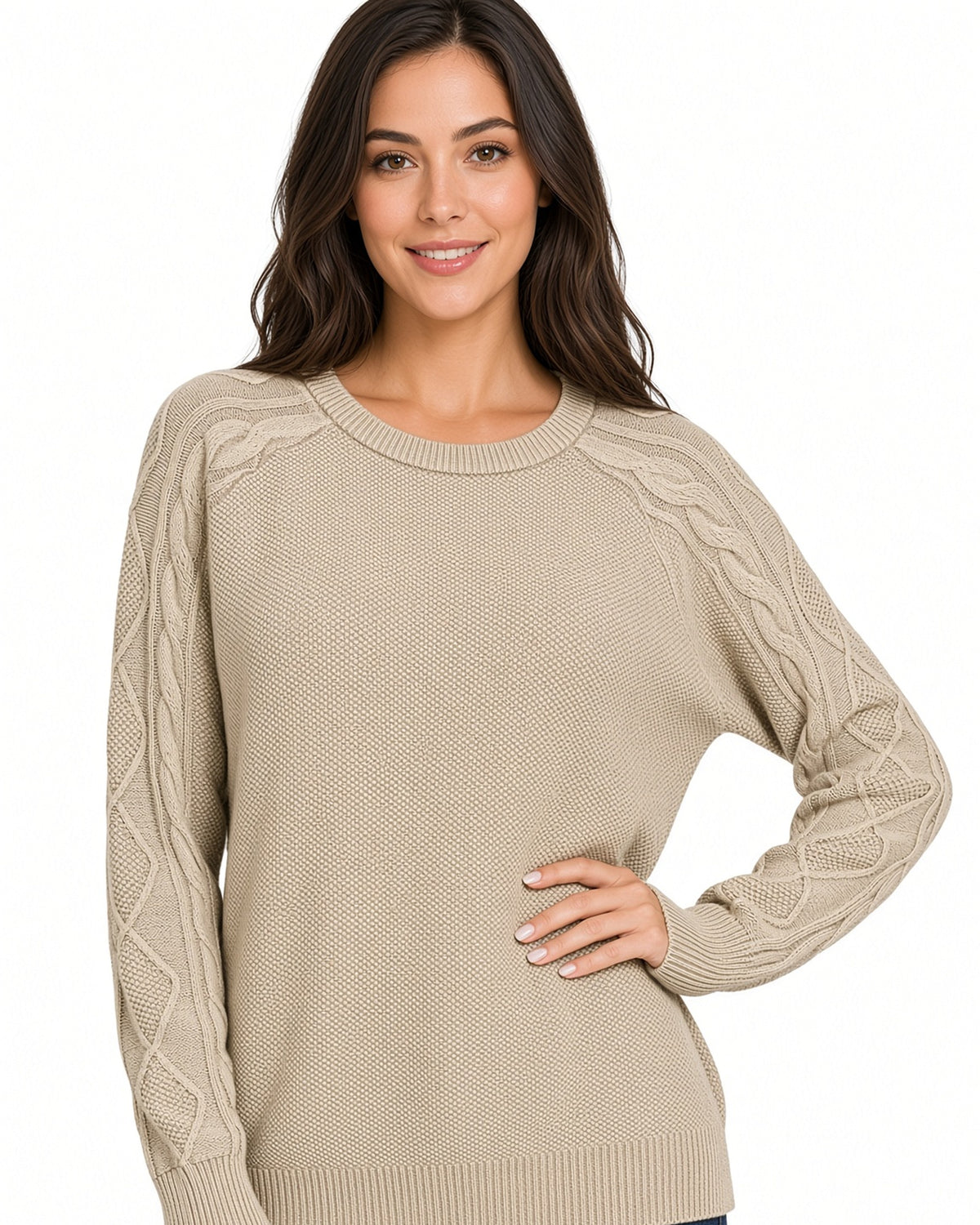 A woman wearing a beige cable-knit crewneck sweater, posing against a solid white background.