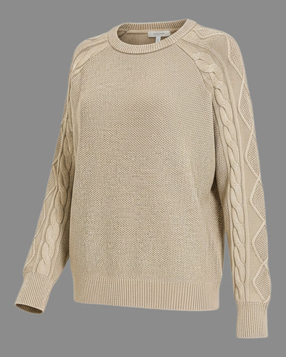 A beige cable-knit crewneck sweater with raglan sleeves, featuring textured cable patterns down the sleeves, shown against a solid gray background.