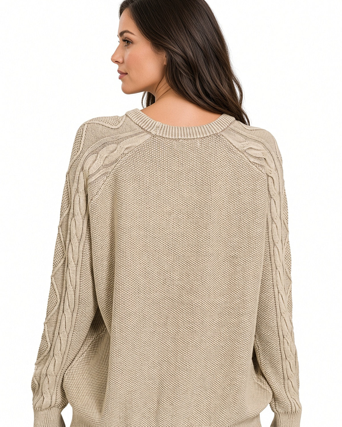A woman shown from the back wearing a beige cable-knit sweater against a plain white background.