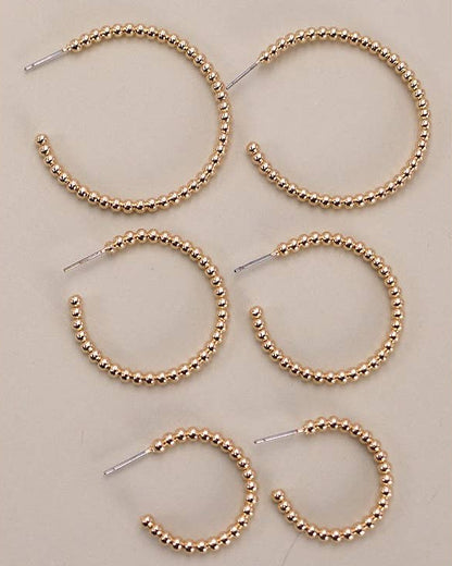 3 pairs of gold ball hoops in small, medium and large sizes. 