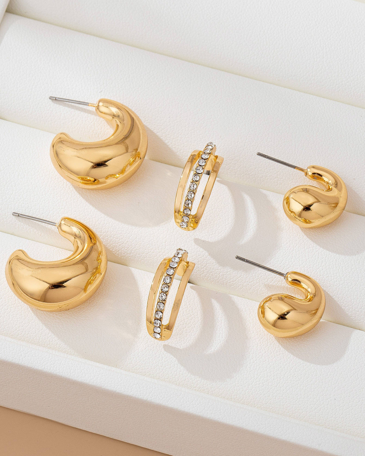 Gold trio bubble hoops and double gold band with rhinestone hoop.
