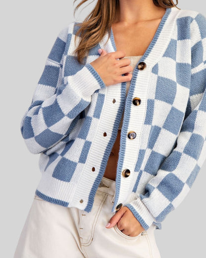 Blue and ivory checkerboard cardigan with V-neckline, contrast trim, and tortoise-style buttons.