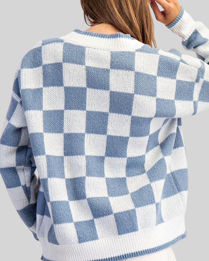 Back view of a blue and white checkerboard cardigan sweater. 
