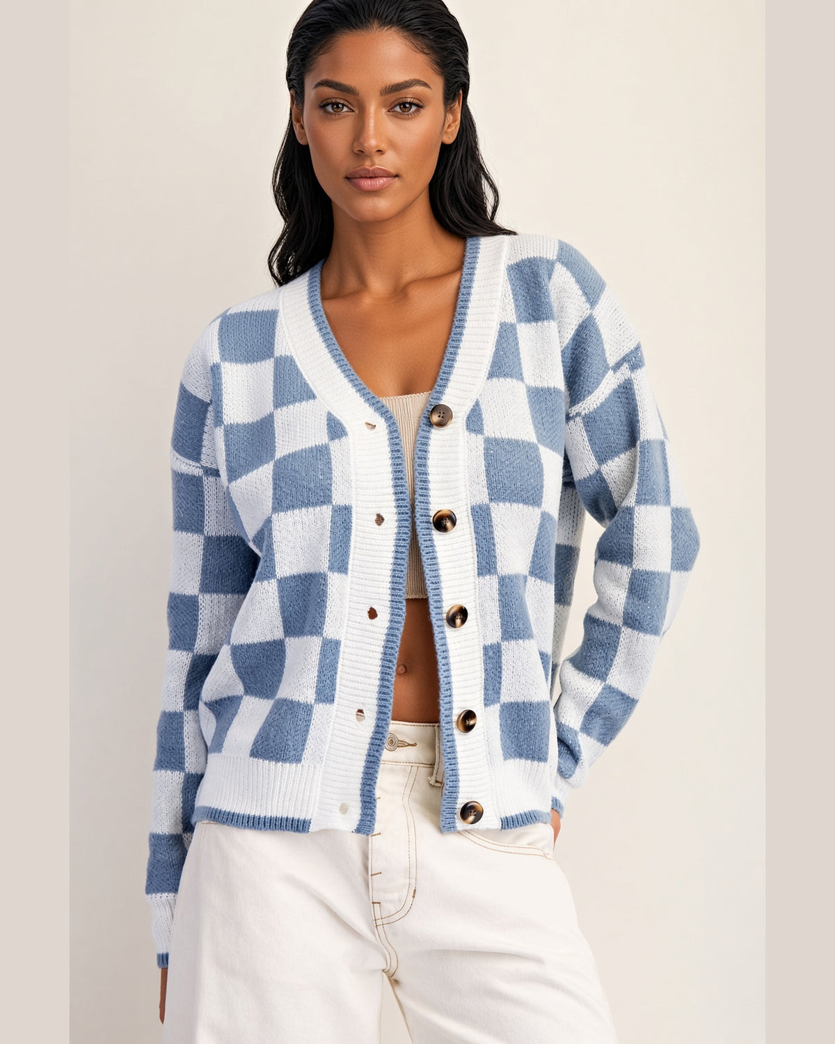 Blue and ivory checkerboard cardigan with V-neckline, contrast trim, and tortoise-style buttons.