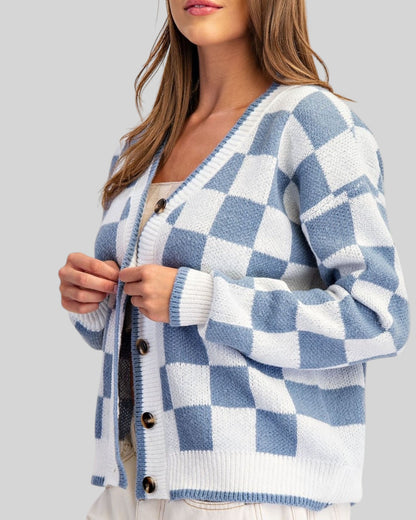 Blue and ivory checkerboard cardigan with V-neckline, contrast trim, and tortoise-style buttons.