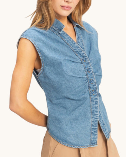 Tailored sleeveless shirt worn by a person on a white background