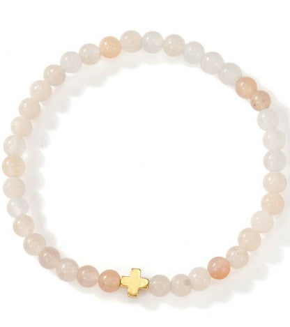 Beaded bracelet with a gold cross charm on a white background.