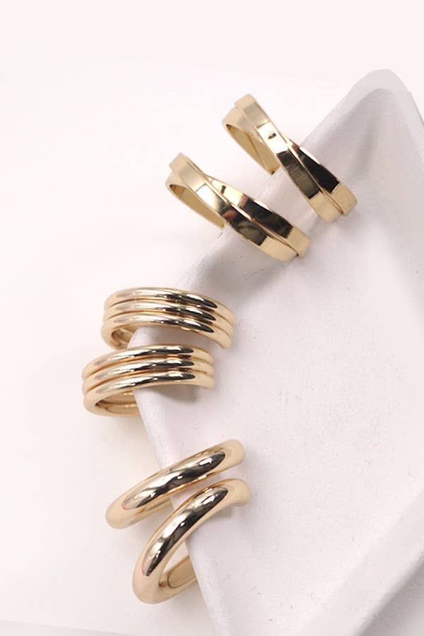 Three different pairs of gold earrings in different sizes. 